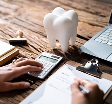 Parent using calculator to determine cost of braces