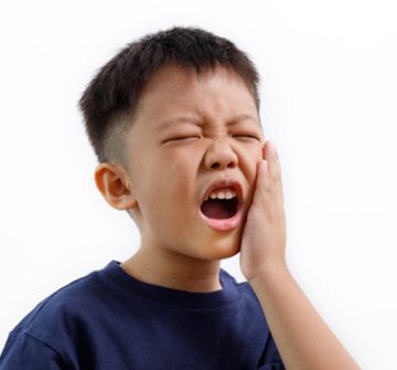 a child suffering from tooth pain