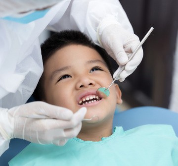 a child having their teeth inspected