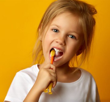 a child brushing her teeth