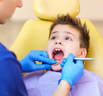 a child having their teeth inspected