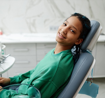 Smiling teen sitting in treatment chair