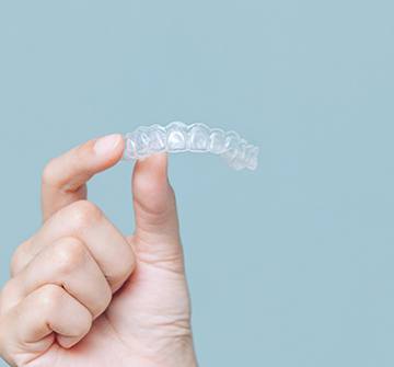 Patient holding clear aligner