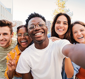 Group of teens smiling while taking photo