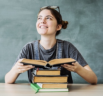 student reading a book and smiling