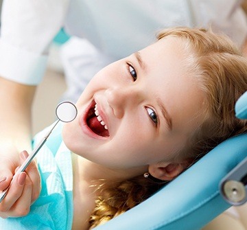 Smiling young girl in dental chair