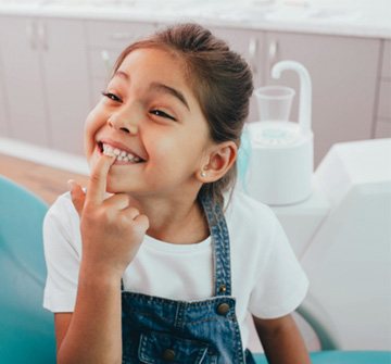 a child pointing to her teeth in New Britain