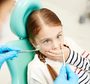A young girl sitting in the dentist’s chair and preparing to undergo treatment for a pediatric dental emergency in New Britain