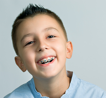 a child with braces smiling