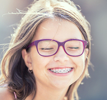 A young girl wearing braces.