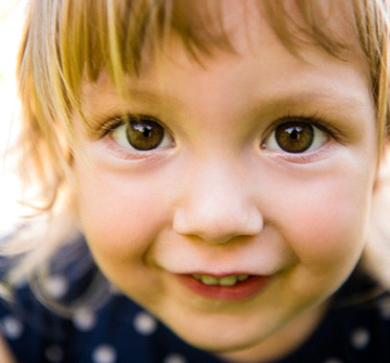 A young child smiling.