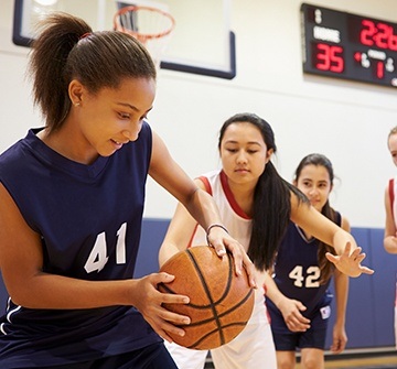 Teen girls playing basketball