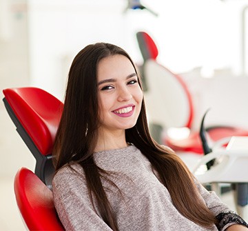 Teen smiling while sitting in treatment chair