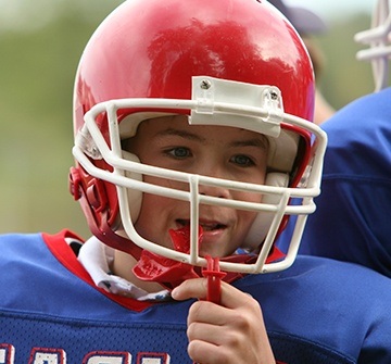 Teen boy placing mouthguard