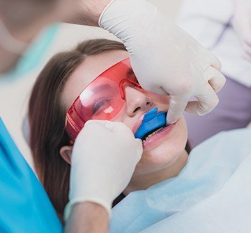 Teen receiving fluoride treatment