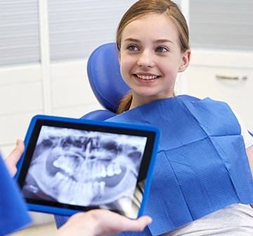 Teen girl smiling in dental chair