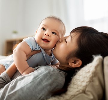 Mom kissing baby on cheek