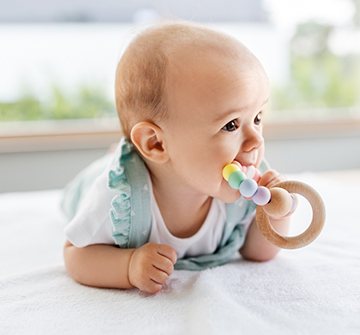 Baby chewing on teething ring