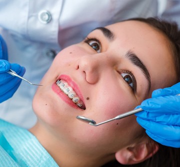 Girl smiling in dental chair with braces