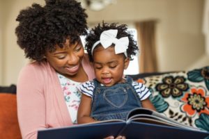 Mother and daughter reading before visiting New Britain children's dentist