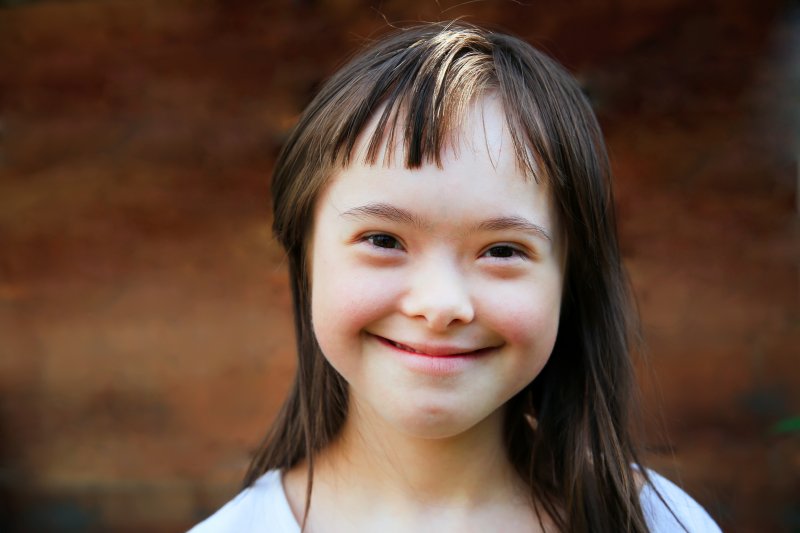 Closeup of young girl with down syndrome smiling