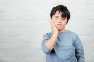 a child suffering from tooth pain 