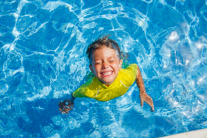 a child cooling off in a swimming pool