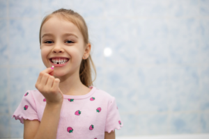 a child holding their lost tooth